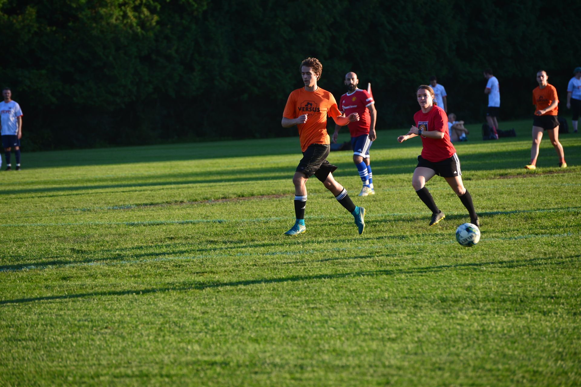 A Social Sports league is playing soccer on a field in Vermont.