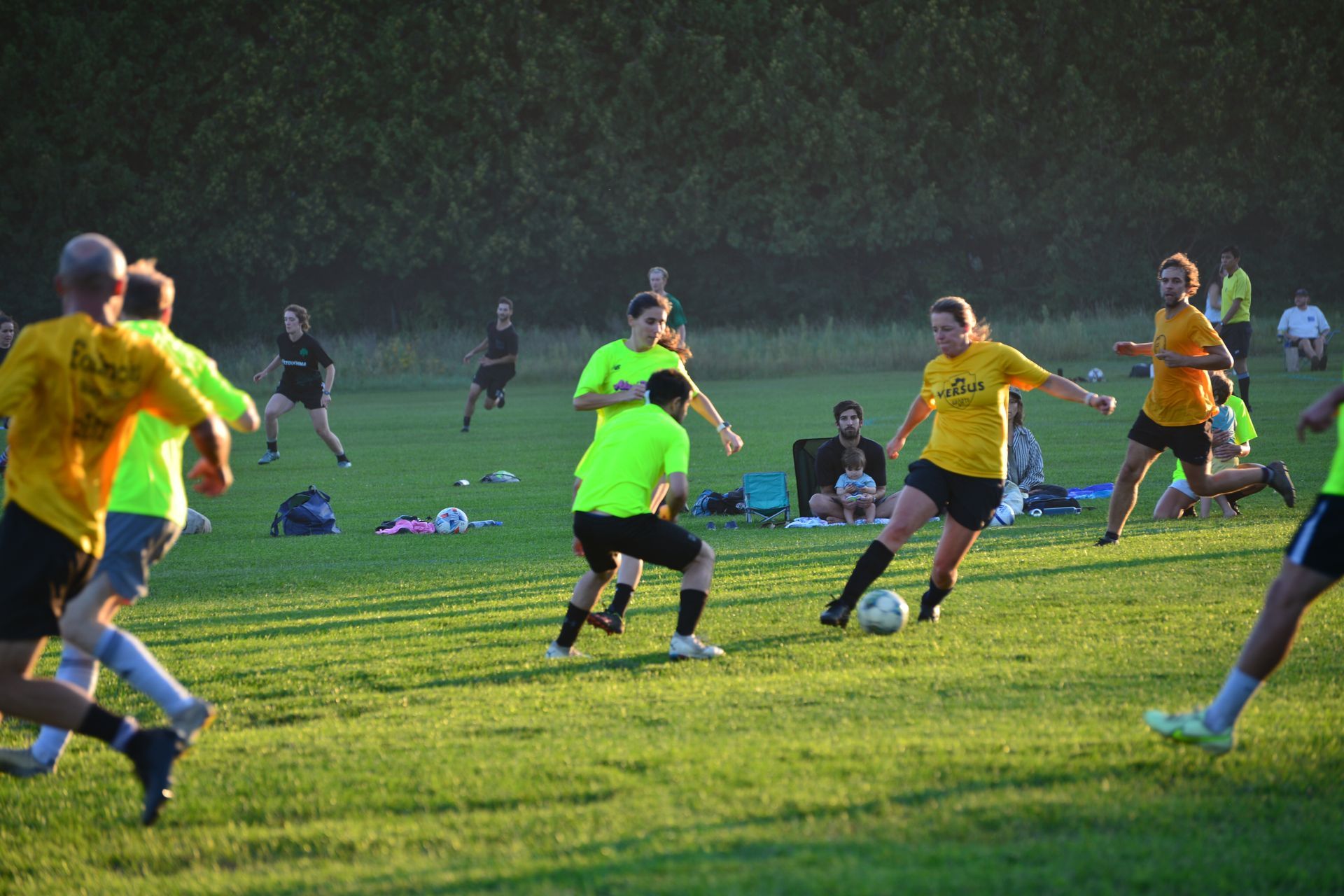 A group of people are playing soccer on a field.