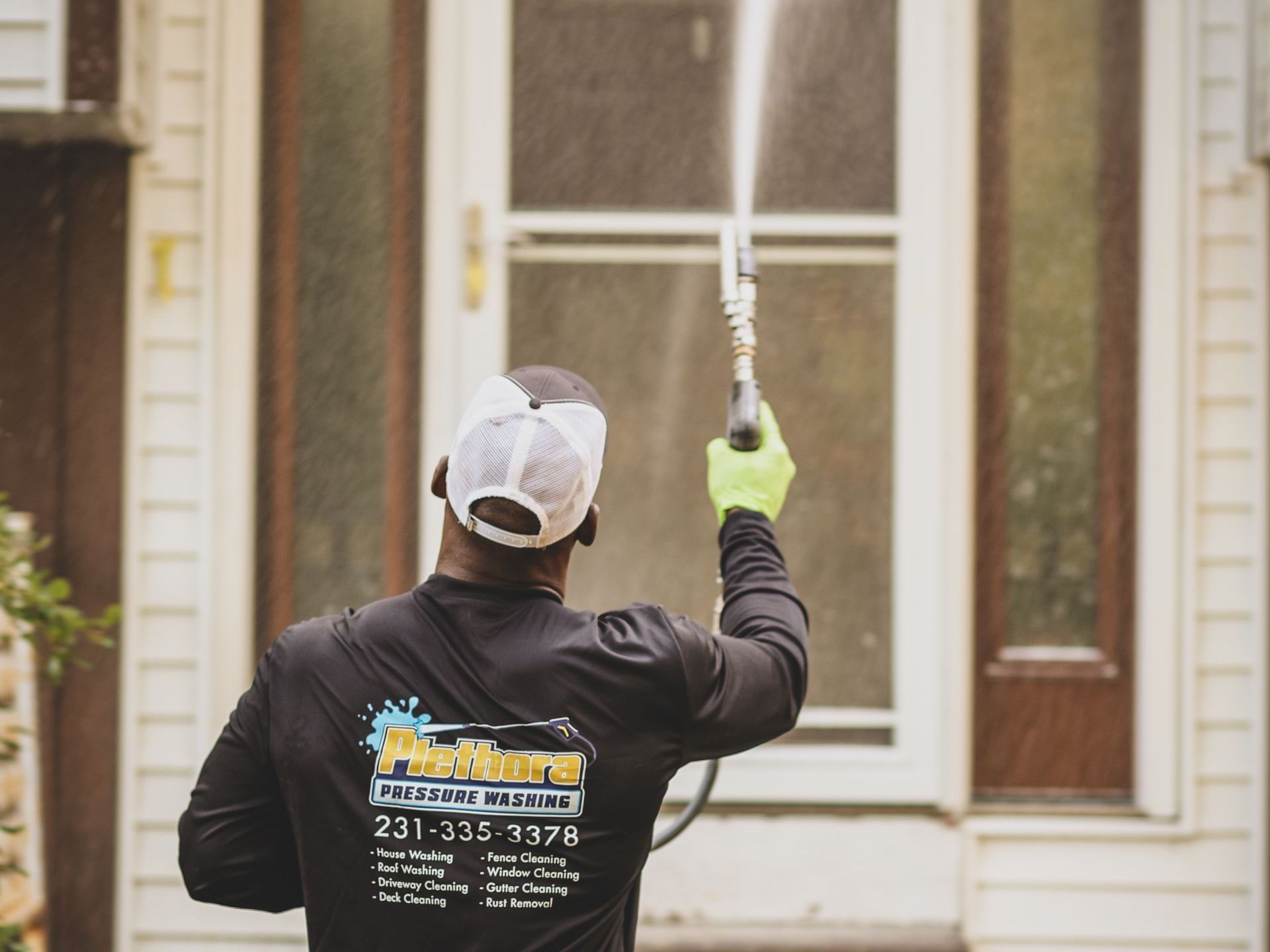 a man wearing a shirt that says pietura pressure washing