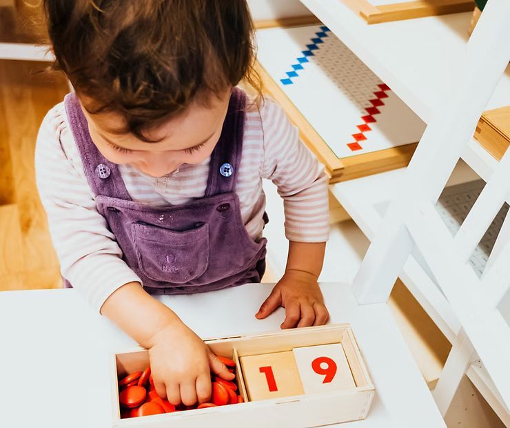 montessori toddler engaging with math activity