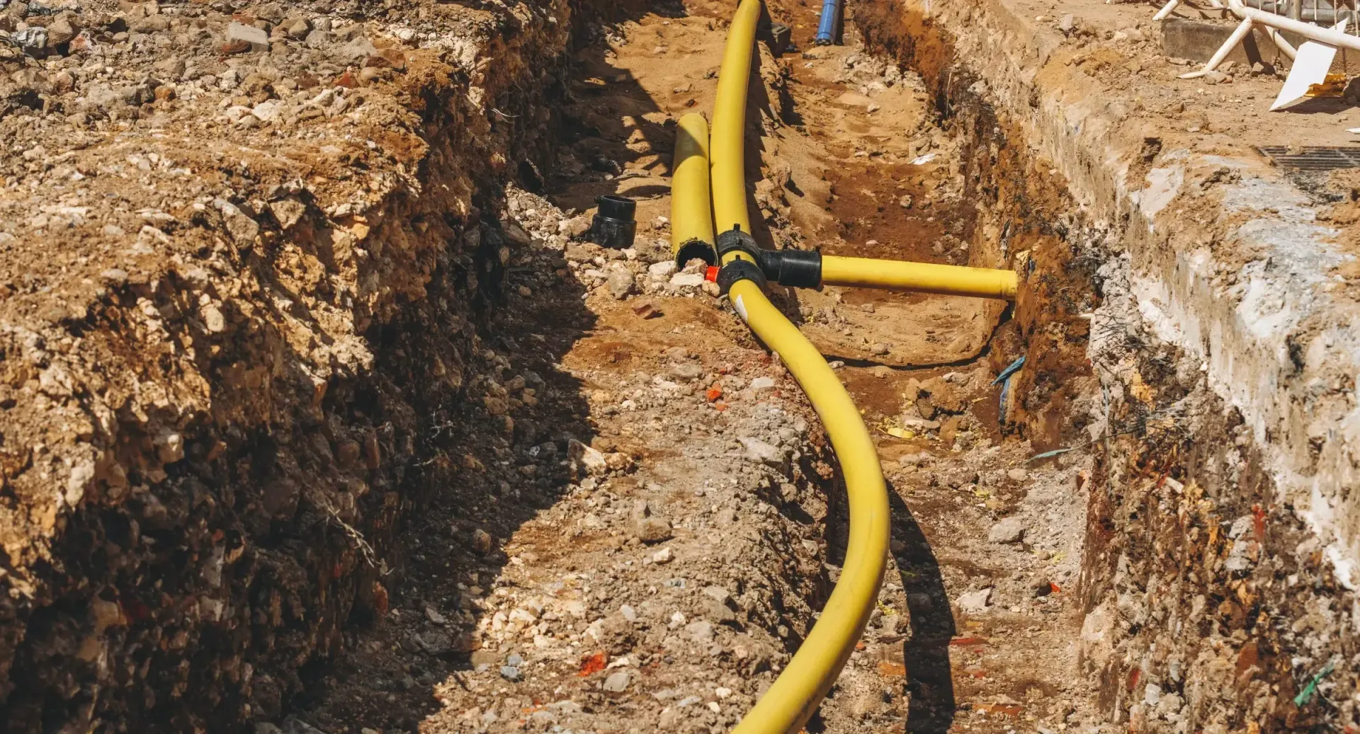 Yellow gas pipes in a trench.