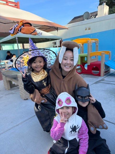 A group of children dressed in halloween costumes posing for a picture