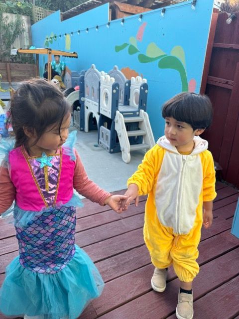 A boy and a girl are holding hands on a deck