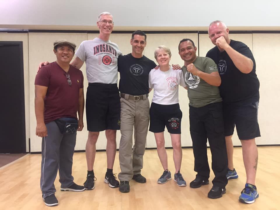 Chocolate dessert, sliced, wrapped in paper, with cinnamon, star anise, and coffee beans on a wooden board.