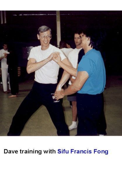 Man in white shirt and glasses practicing Wing Chun with Sifu Francis Fong.