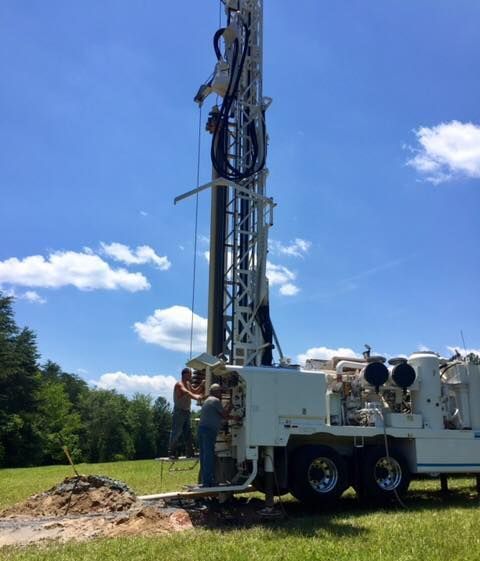Looking up at an oil rig with a blue sky in the background.