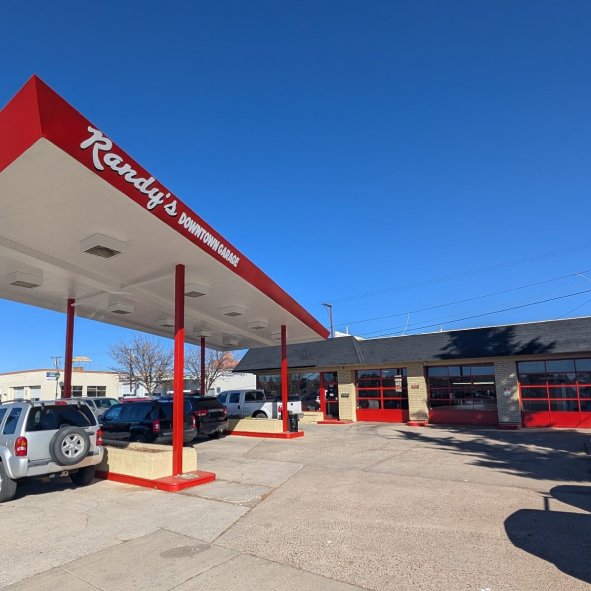 A randy 's gas station with cars parked underneath it | Randy's Downtown Garage