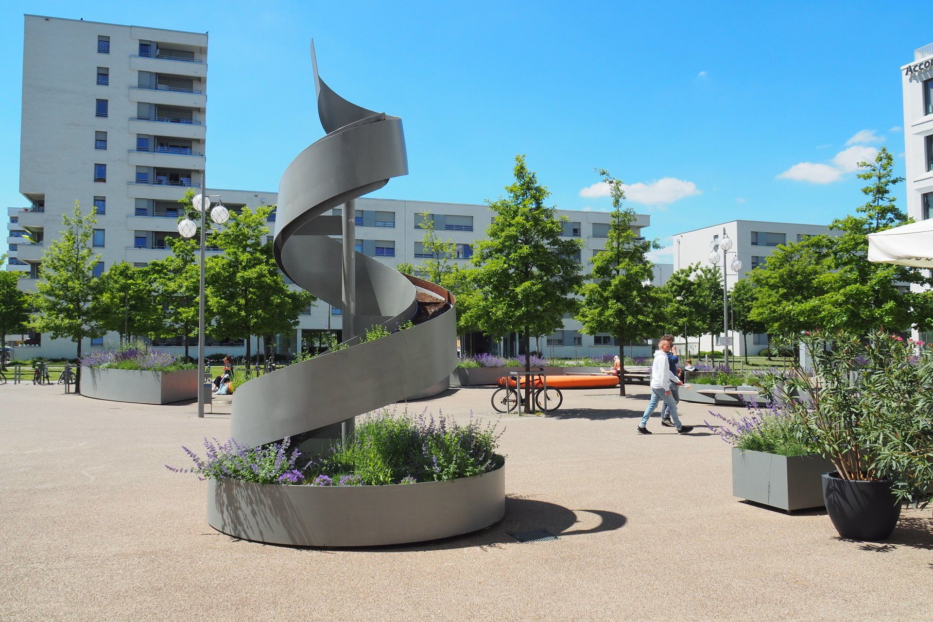 A person is riding a spiral slide in a park