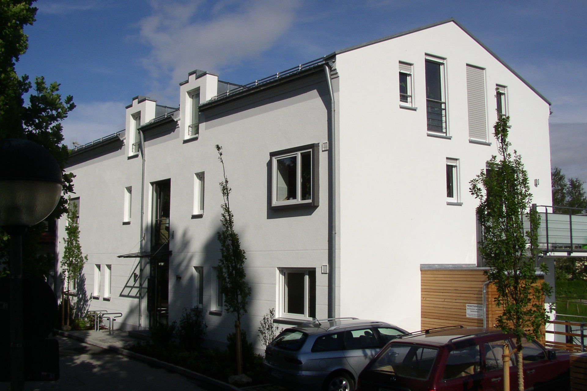 A white building with cars parked in front of it