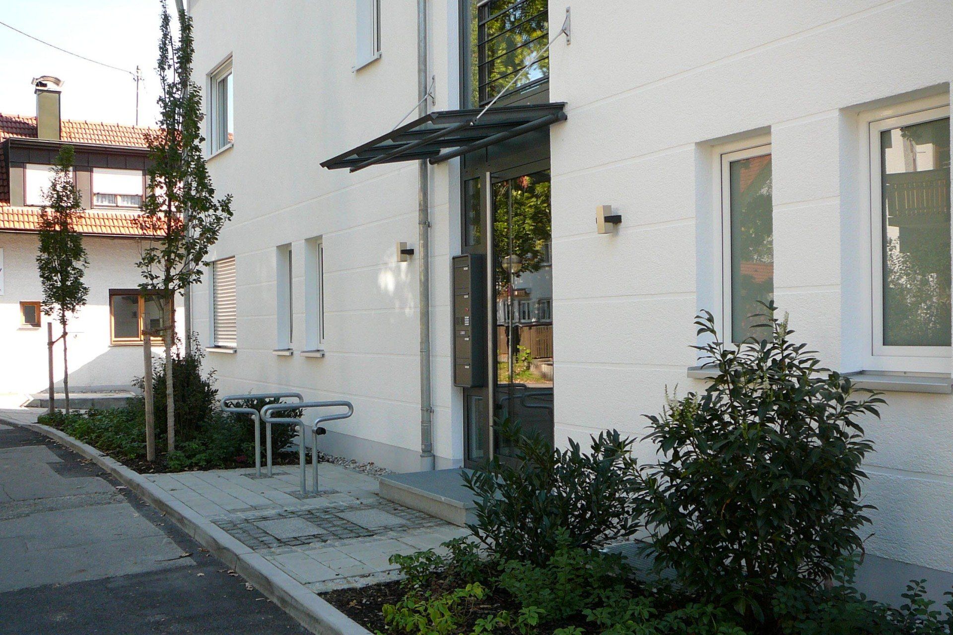 A white building with a canopy over the entrance