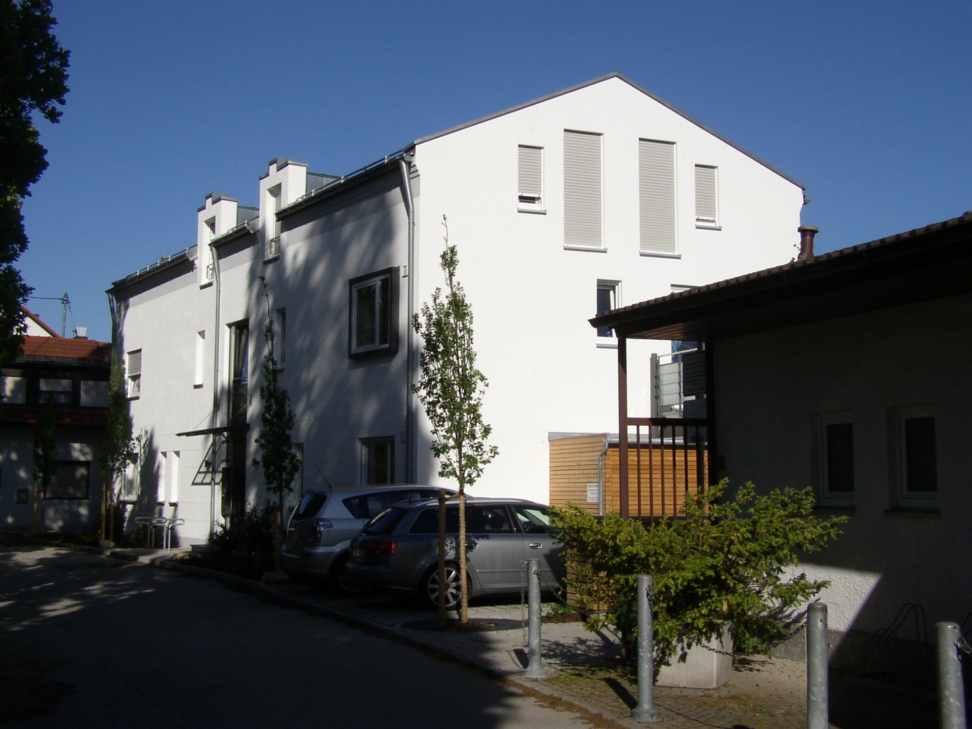 A white building with cars parked in front of it