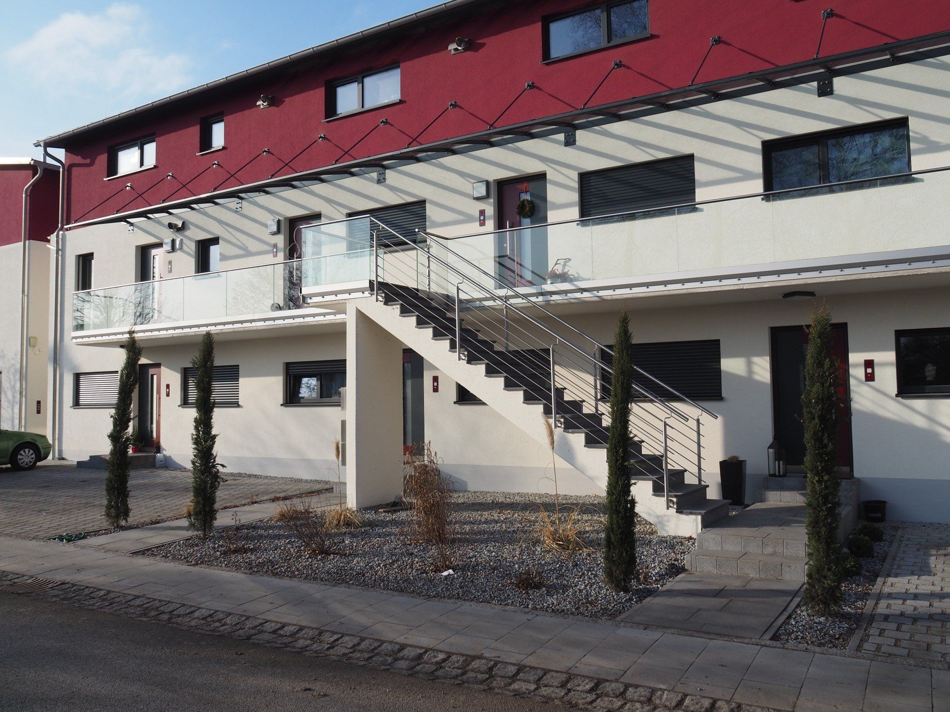 A red and white building with stairs leading up to the second floor