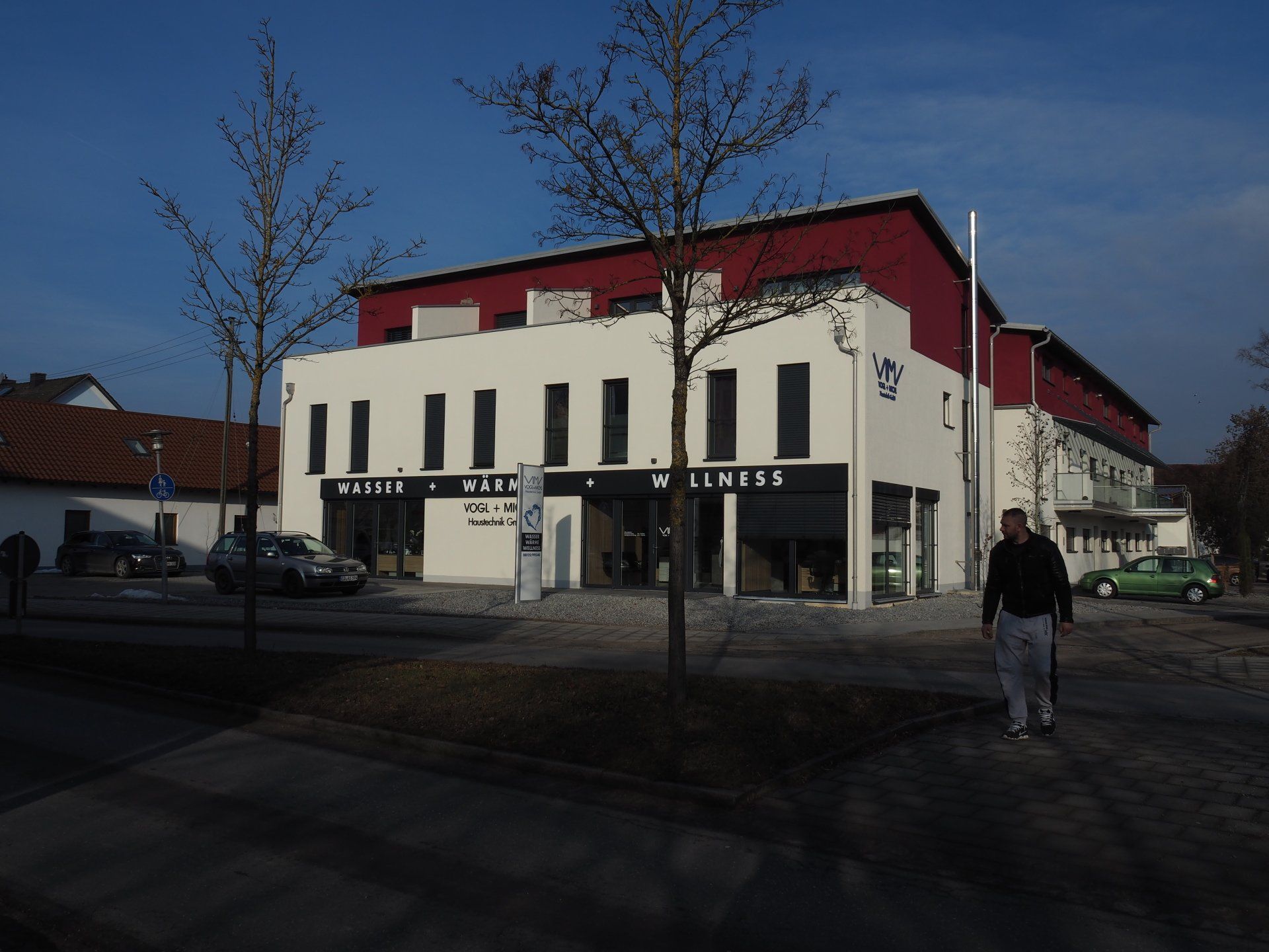 A man walking in front of a building that says lindt