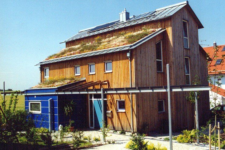 A large wooden house with a green roof