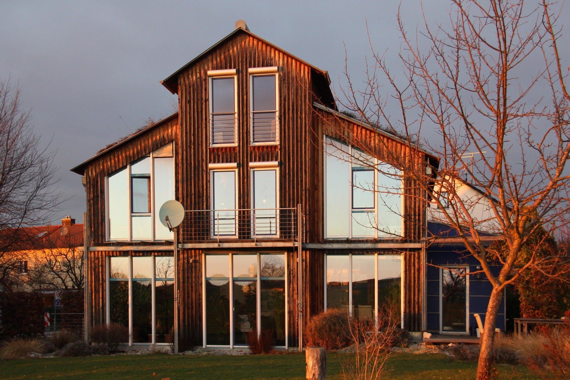 A large house with a lot of windows and a satellite dish