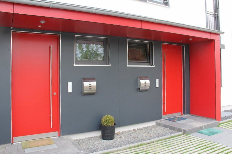 A building with two red doors and a mailbox