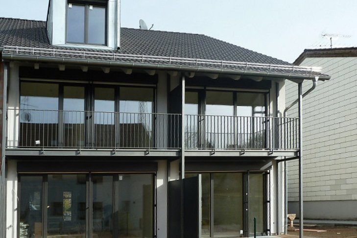 A house with a balcony and a lot of windows