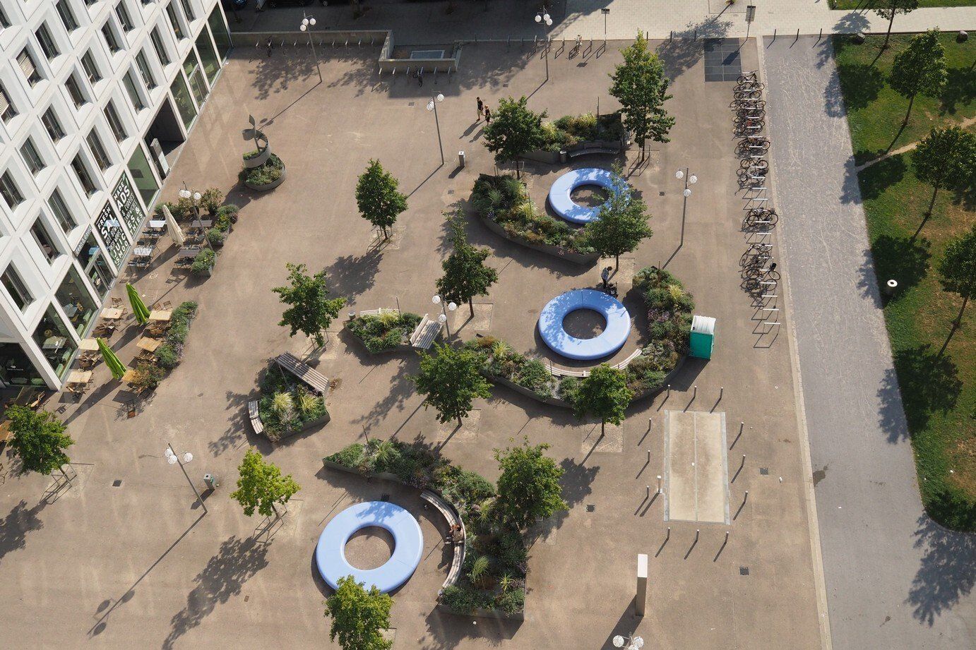 An aerial view of a park with a building in the background