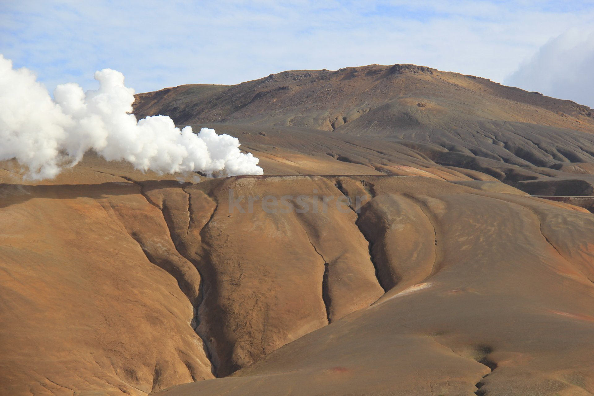 A mountain with a lot of smoke coming out of it