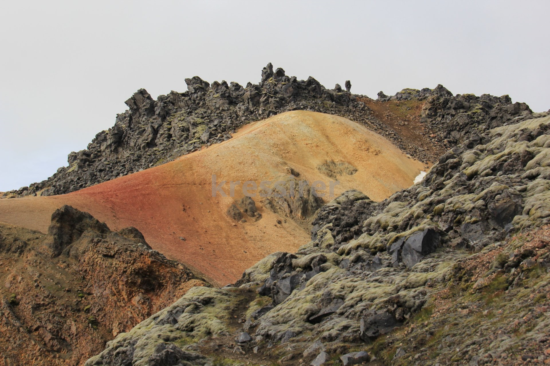 A mountain with a lot of rocks and grass on it