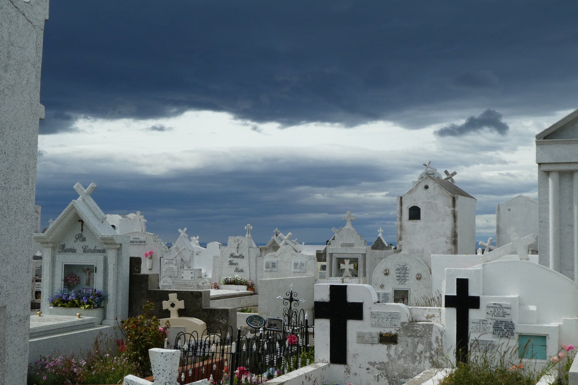 A cemetery with a lot of graves and crosses