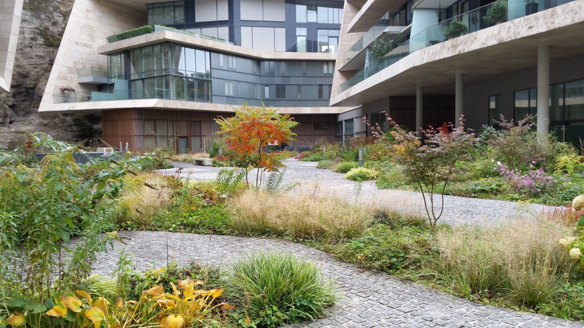 A large building with a garden in front of it.