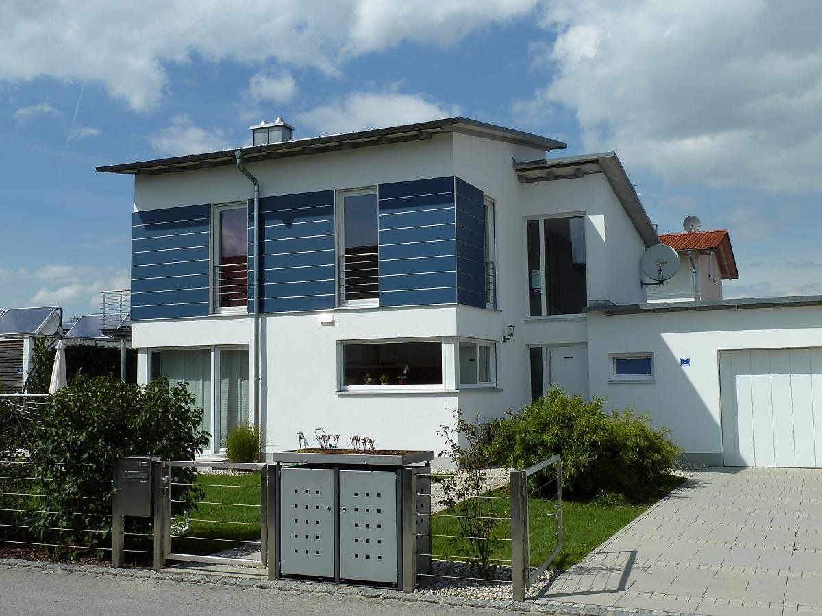 A white house with blue shutters on the windows