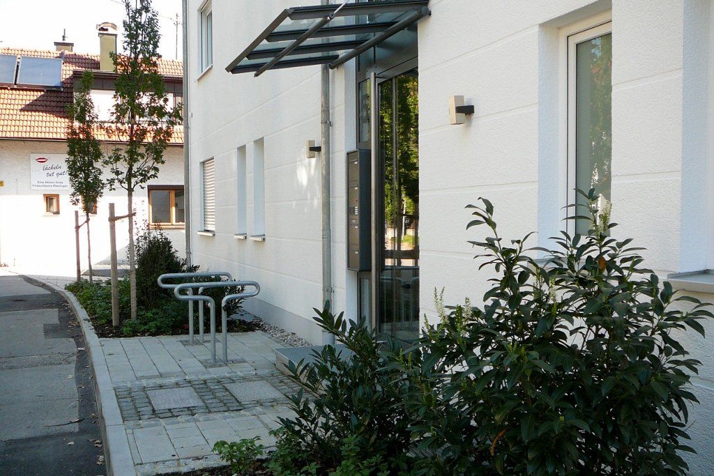 A white building with a canopy over the entrance
