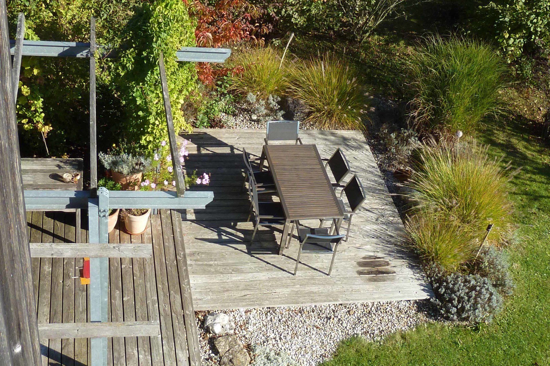 A wooden deck with a table and chairs on it