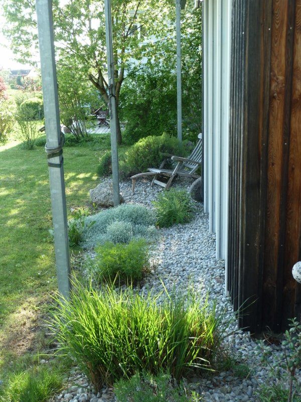 There is a chair in the backyard of a house.