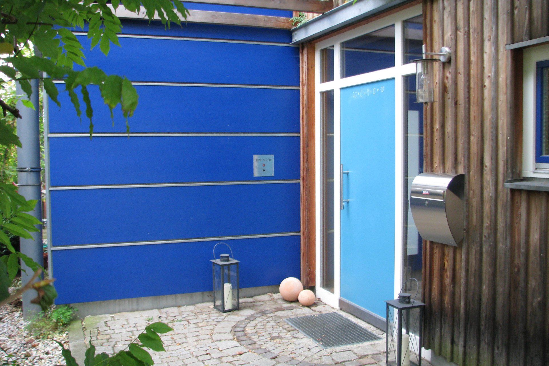 A blue door with a mailbox in front of it