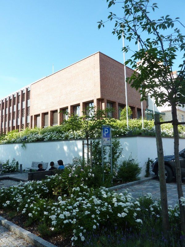 A brick building with a handicapped parking sign in front of it