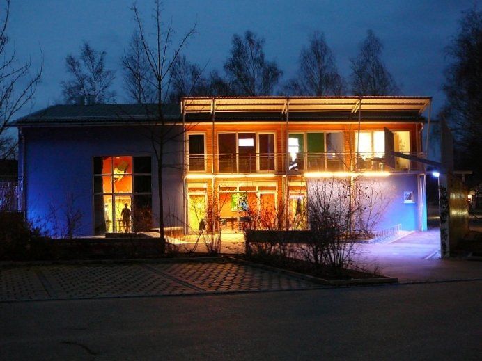 A large building with a lot of windows is lit up at night
