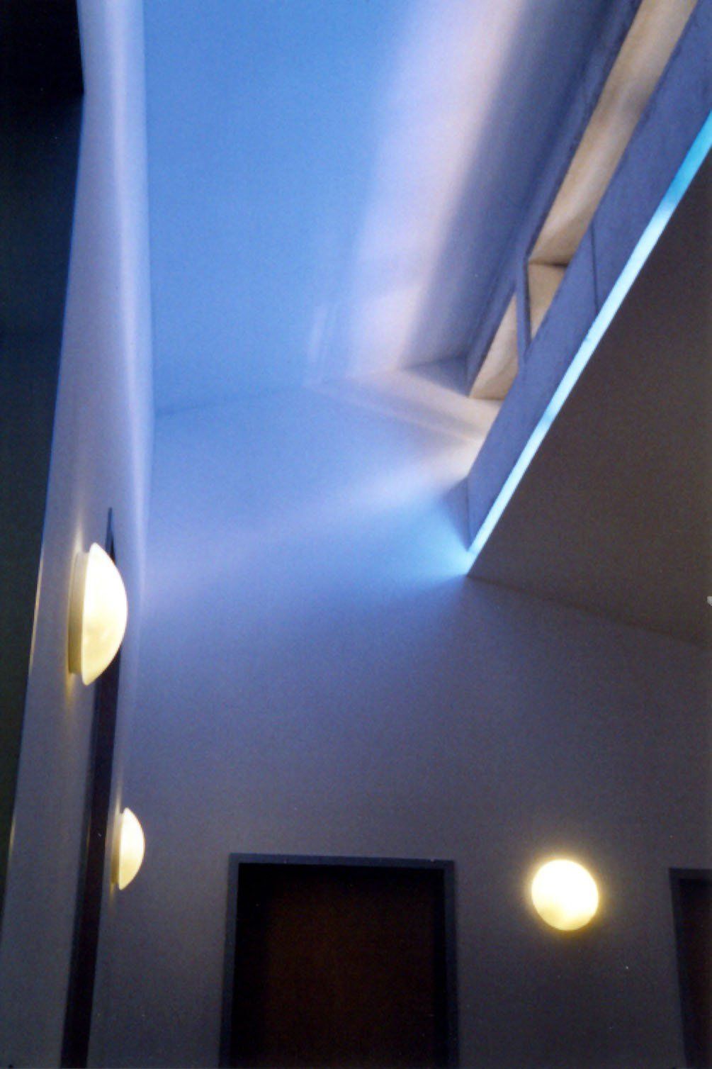 A hallway with a blue light on the ceiling