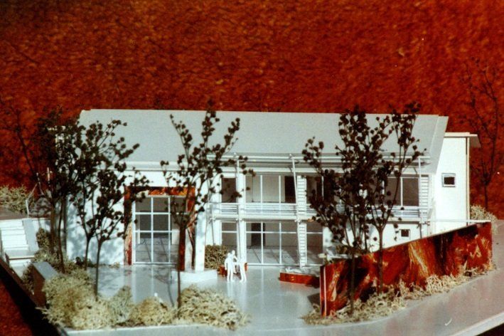 A model of a house with trees in front of it