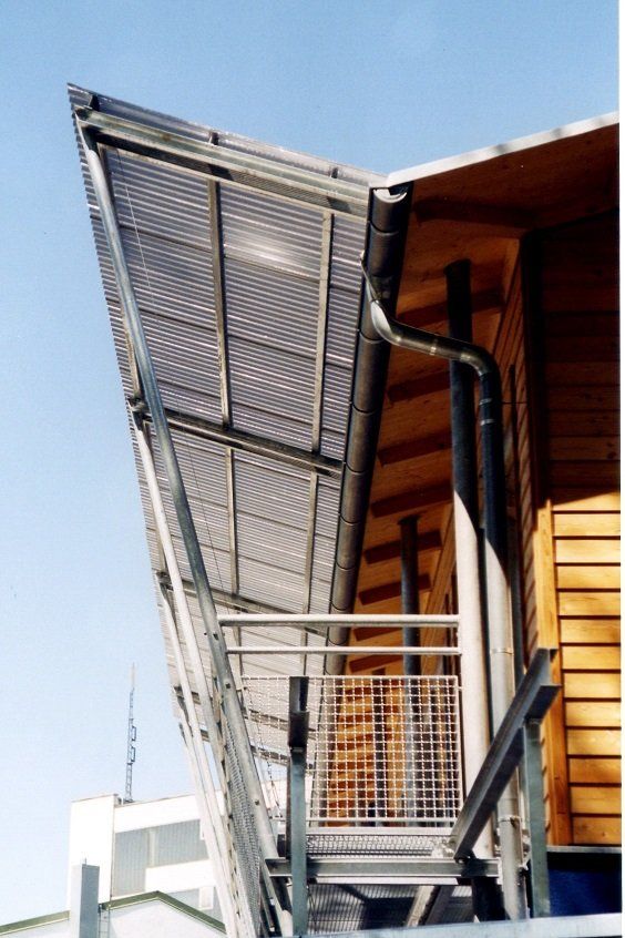 A staircase leading up to a balcony on the side of a building