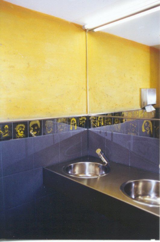 A bathroom with two sinks and a mirror