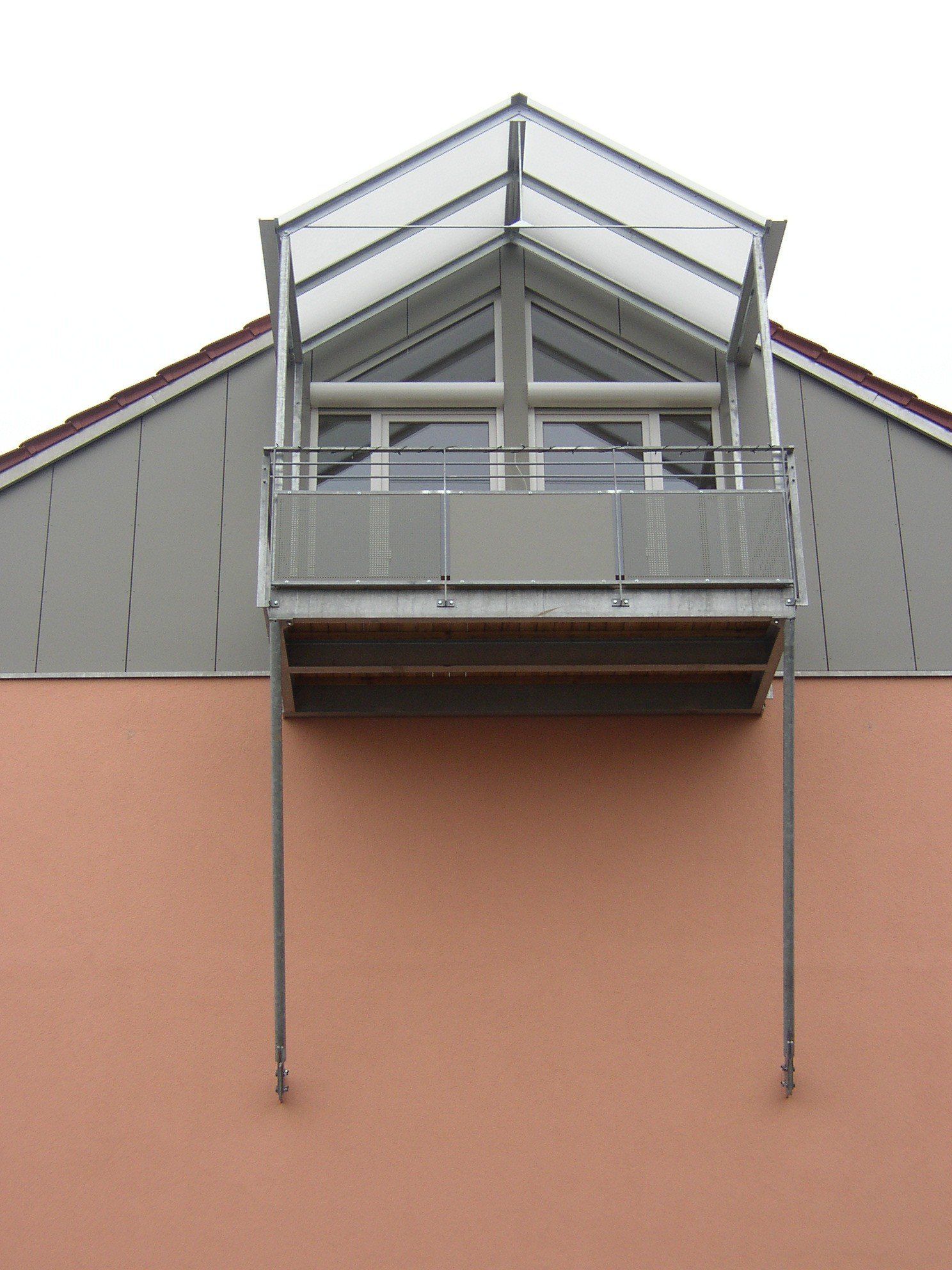 A balcony on the side of a building with a clear roof