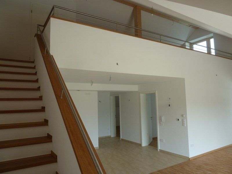 An empty room with stairs leading up to the second floor