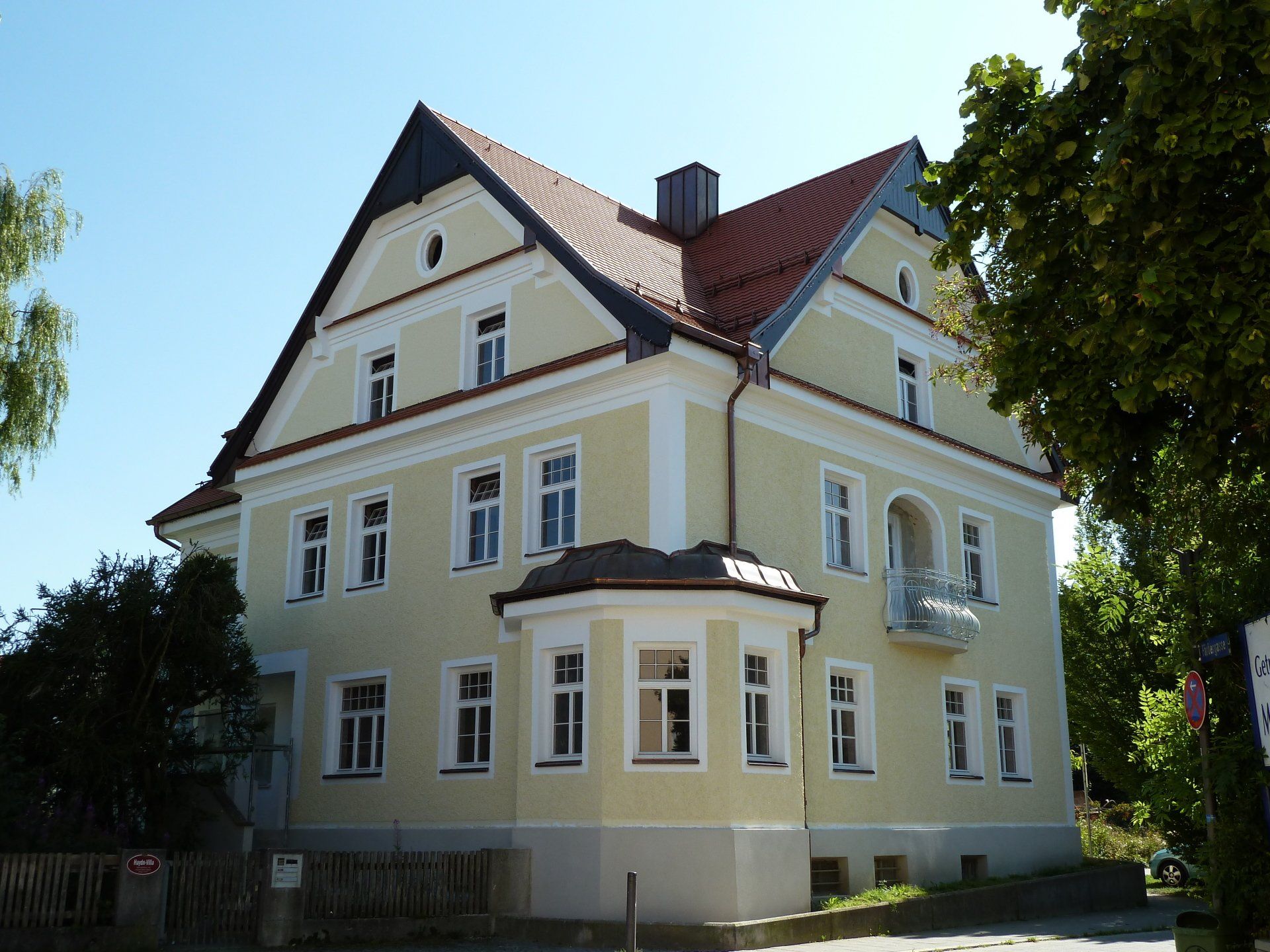 A large yellow building with a red tile roof