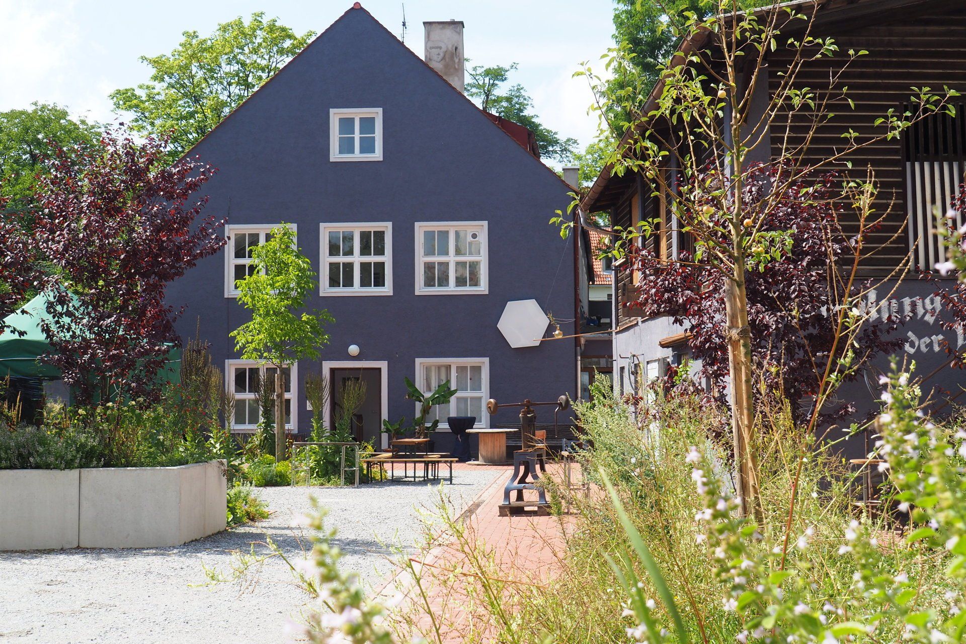 A large house with a lot of windows and flowers in front of it
