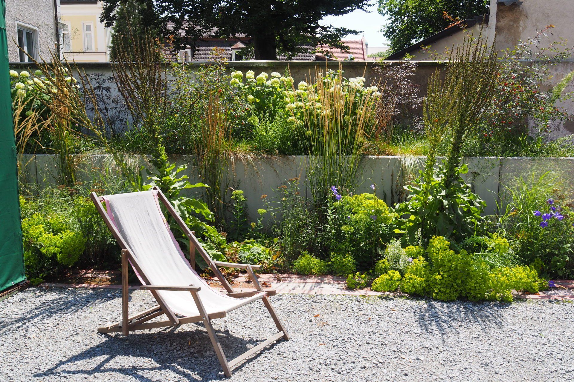 A lawn chair is sitting in the middle of a garden