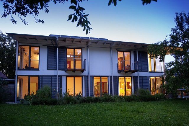 A house with a lot of windows and a balcony