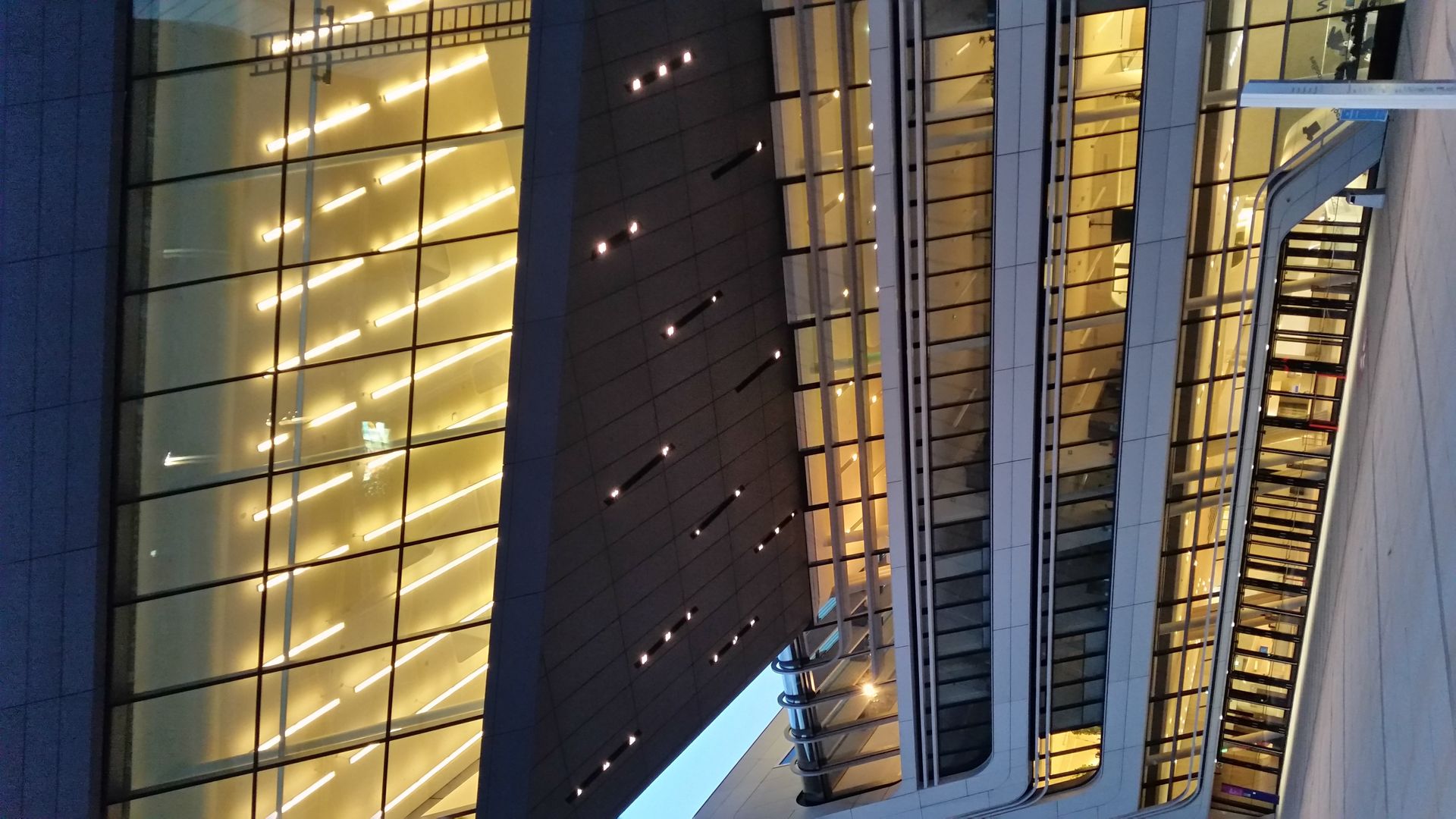 A building with a lot of windows is lit up at night