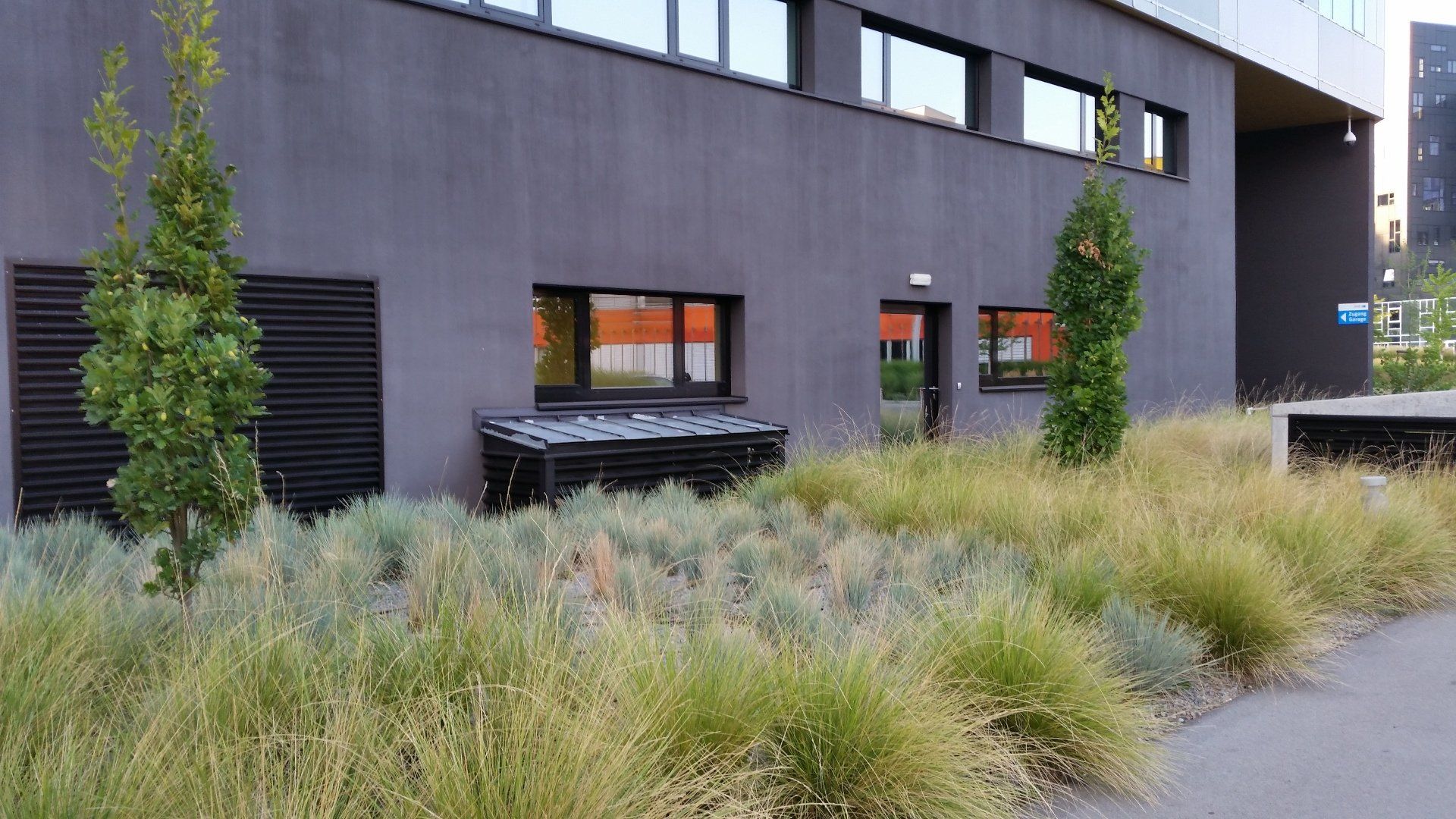 A large building with a lot of grass in front of it.