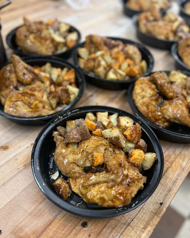A wooden table topped with plates of food.