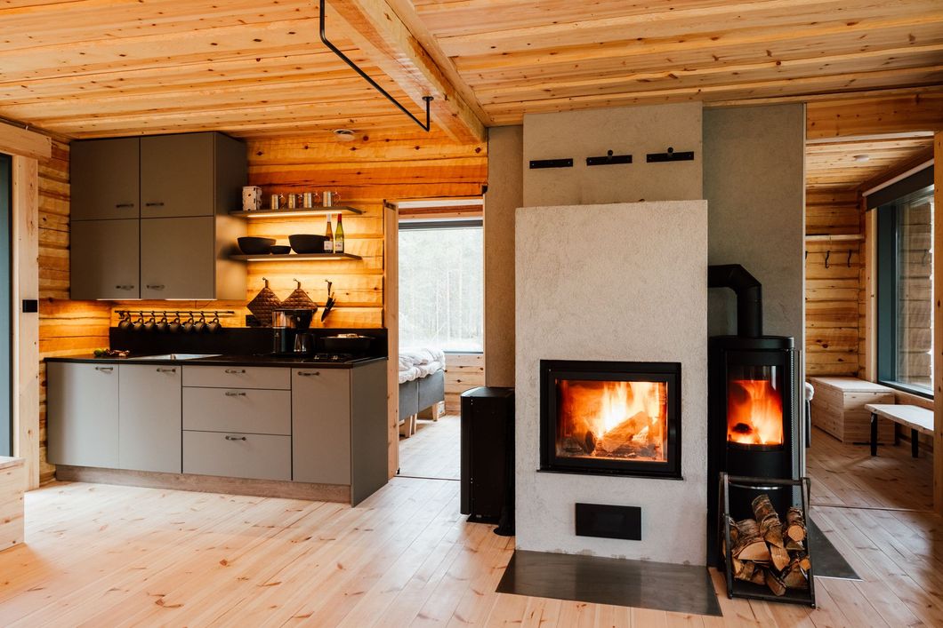 A kitchen and a fireplace in a log cabin