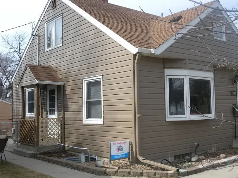 A house with a sign in front of it that says ' a ' on it
