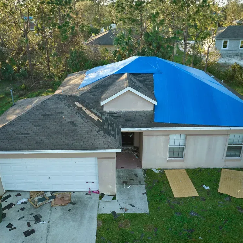 An aerial view of a house with a blue roof