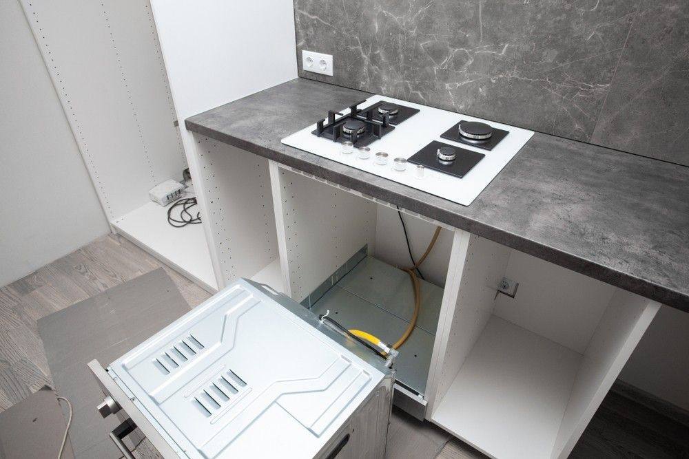 A Kitchen With a Stove Top Oven and a Microwave — A J Wilcox Air & Electrical in Banora Point, NSW